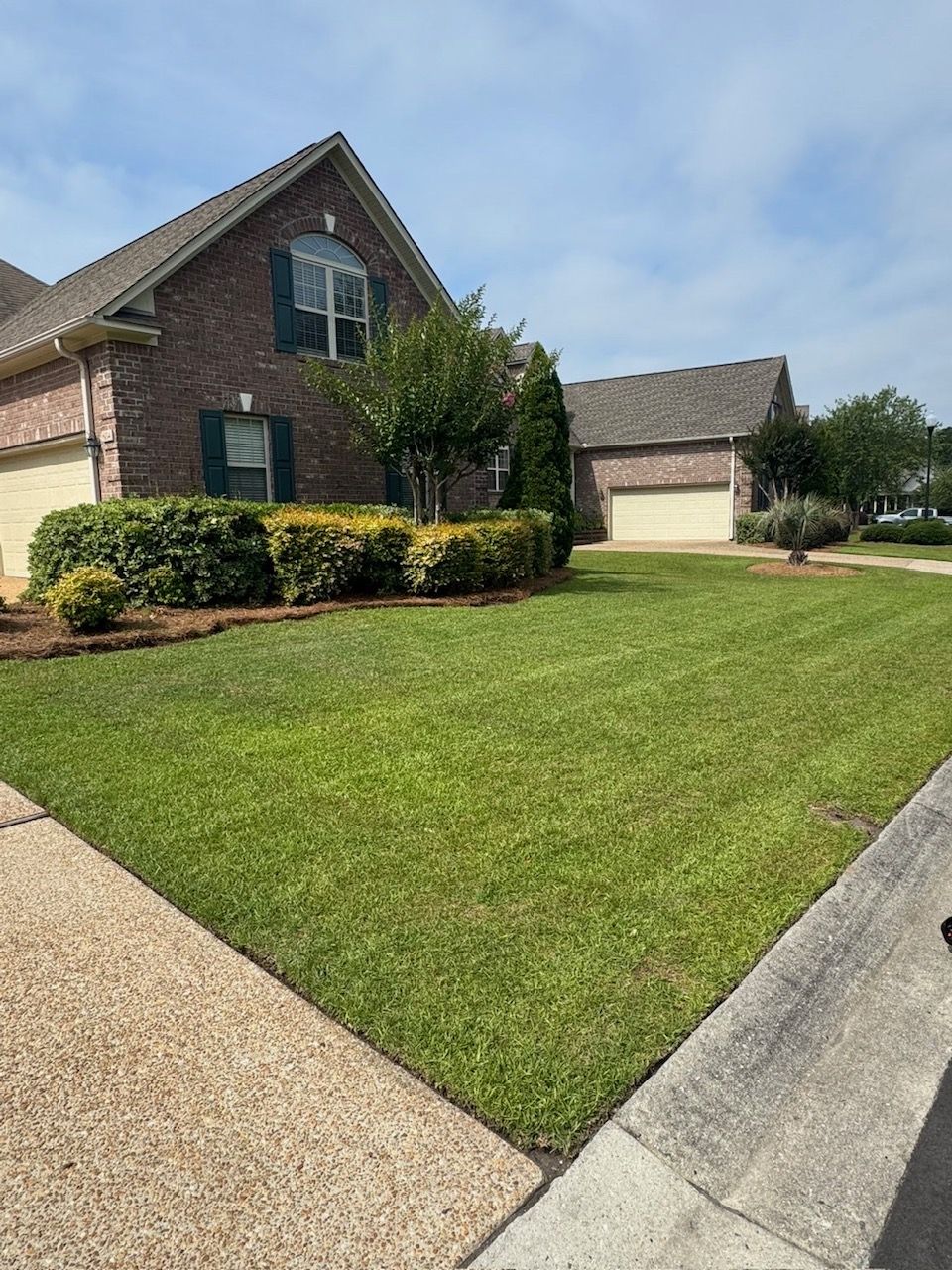 Manicured front yard with landscaped beds, Wilmington NC